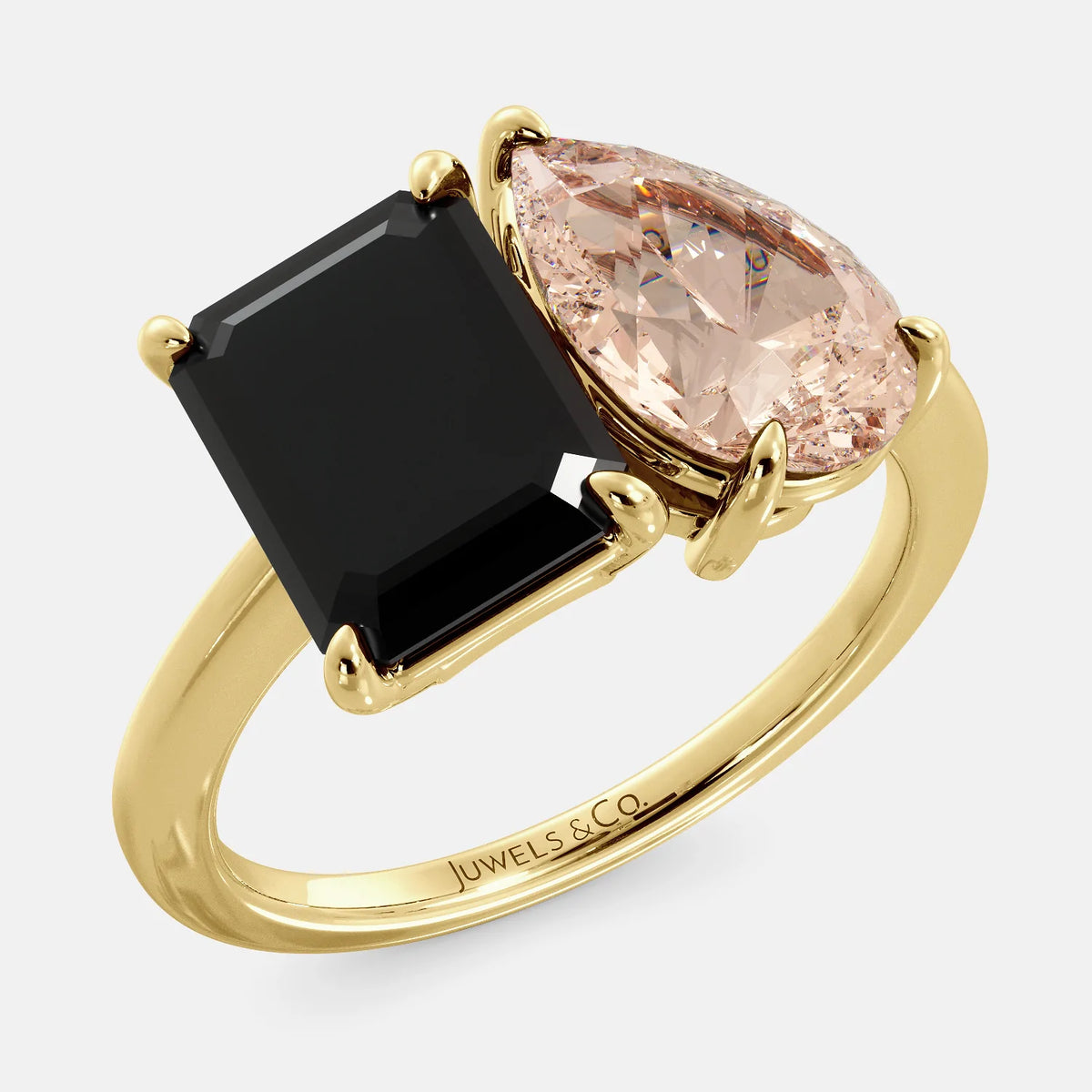 A toi et moi ring with a onyx stone in emerald cut and a pear-shaped stone. The onyx is a deep dark color and the pear-shaped stone can be customized to represent the birth month stone of the wearer or a loved one. The ring is made of 14k gold and is available in all sizes. This ring is a perfect gift for any occasion, and it can be customized to make it truly unique.