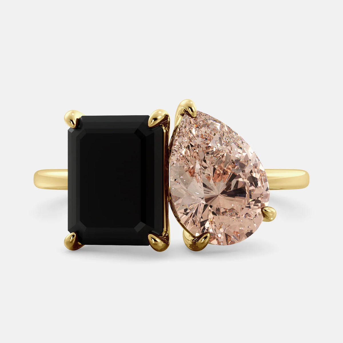 A toi et moi ring with a onyx stone in emerald cut and a pear-shaped stone. The onyx is a deep dark color and the pear-shaped stone can be customized to represent the birth month stone of the wearer or a loved one. The ring is made of 14k gold and is available in all sizes. This ring is a perfect gift for any occasion, and it can be customized to make it truly unique.