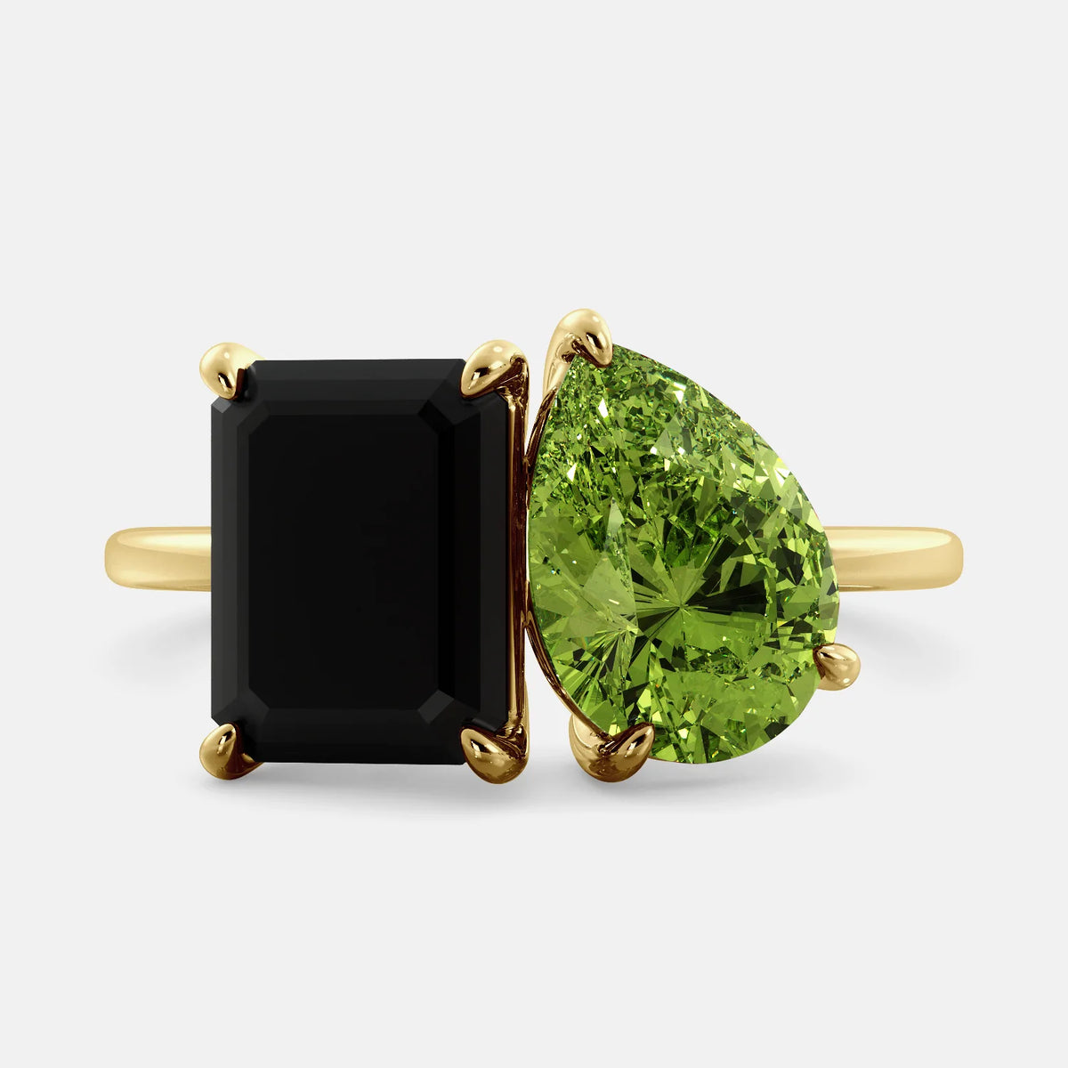 A toi et moi ring with a onyx stone in emerald cut and a pear-shaped stone. The onyx is a deep dark color and the pear-shaped stone can be customized to represent the birth month stone of the wearer or a loved one. The ring is made of 14k gold and is available in all sizes. This ring is a perfect gift for any occasion, and it can be customized to make it truly unique.