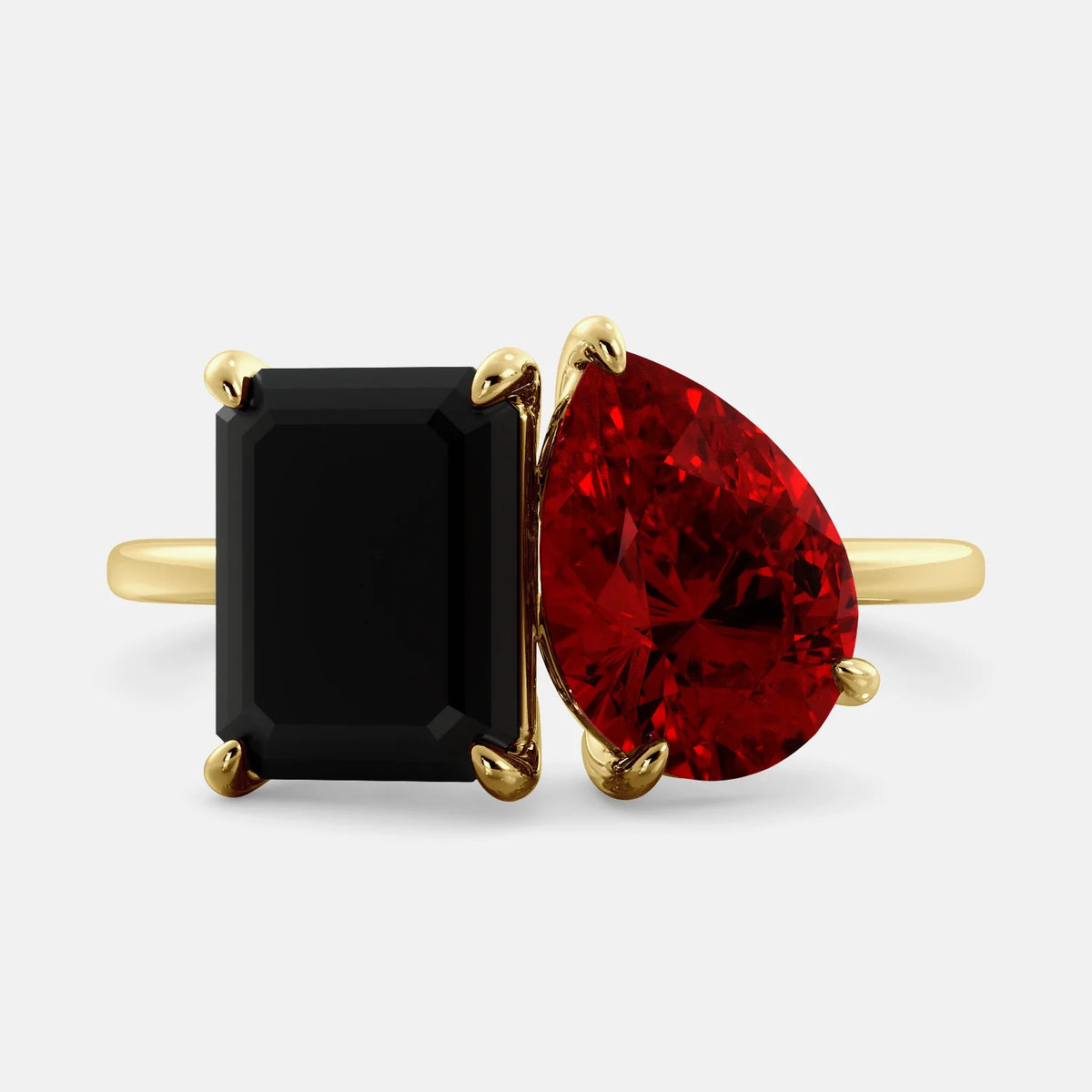A toi et moi ring with a onyx stone in emerald cut and a pear-shaped stone. The onyx is a deep dark color and the pear-shaped stone can be customized to represent the birth month stone of the wearer or a loved one. The ring is made of 14k gold and is available in all sizes. This ring is a perfect gift for any occasion, and it can be customized to make it truly unique.