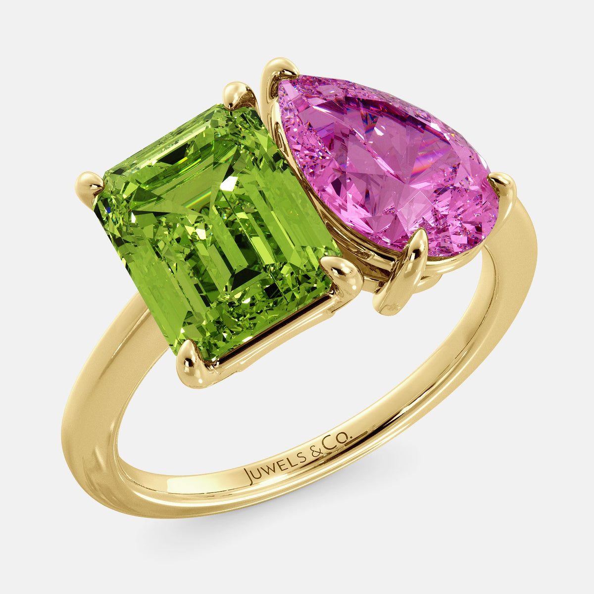 A toi et moi ring with an emerald-cut Green Peridot and a pear-cut gemstone. The emerald-cut morganite is set on the left of the ring, and the pear-cut gemstone is set on the right. The ring is made of recycled yellow gold and has a simple, elegant design. The pear-cut gemstone can be customized. **Here are some additional details about the image:** * The emerald-cut white Green Peridot is a birthstone for August. * The pear-cut gemstone can be customized to any stone of your choice.