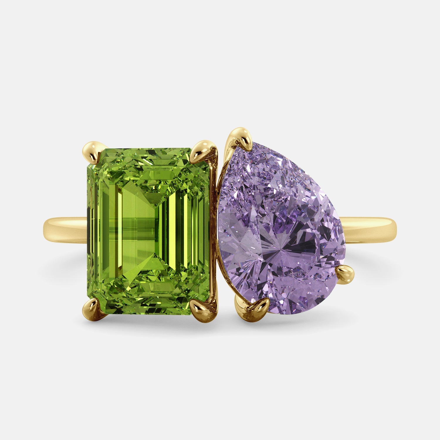 A toi et moi ring with an emerald-cut Green Peridot and a pear-cut gemstone. The emerald-cut morganite is set on the left of the ring, and the pear-cut gemstone is set on the right. The ring is made of recycled yellow gold and has a simple, elegant design. The pear-cut gemstone can be customized. **Here are some additional details about the image:** * The emerald-cut white Green Peridot is a birthstone for August. * The pear-cut gemstone can be customized to any stone of your choice.