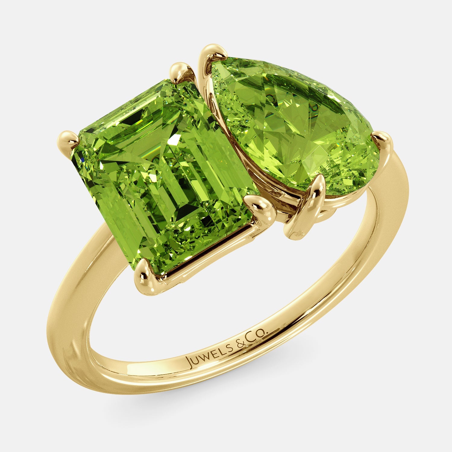 A toi et moi ring with an emerald-cut Green Peridot and a pear-cut gemstone. The emerald-cut morganite is set on the left of the ring, and the pear-cut gemstone is set on the right. The ring is made of recycled yellow gold and has a simple, elegant design. The pear-cut gemstone can be customized. **Here are some additional details about the image:** * The emerald-cut white Green Peridot is a birthstone for August. * The pear-cut gemstone can be customized to any stone of your choice.
