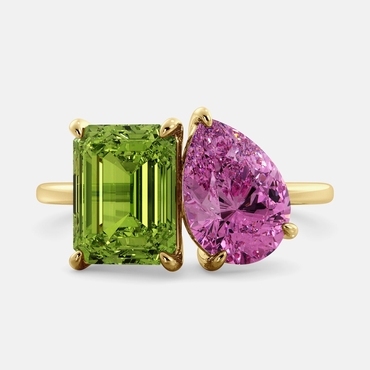A toi et moi ring with an emerald-cut Green Peridot and a pear-cut gemstone. The emerald-cut morganite is set on the left of the ring, and the pear-cut gemstone is set on the right. The ring is made of recycled yellow gold and has a simple, elegant design. The pear-cut gemstone can be customized. **Here are some additional details about the image:** * The emerald-cut white Green Peridot is a birthstone for August. * The pear-cut gemstone can be customized to any stone of your choice.