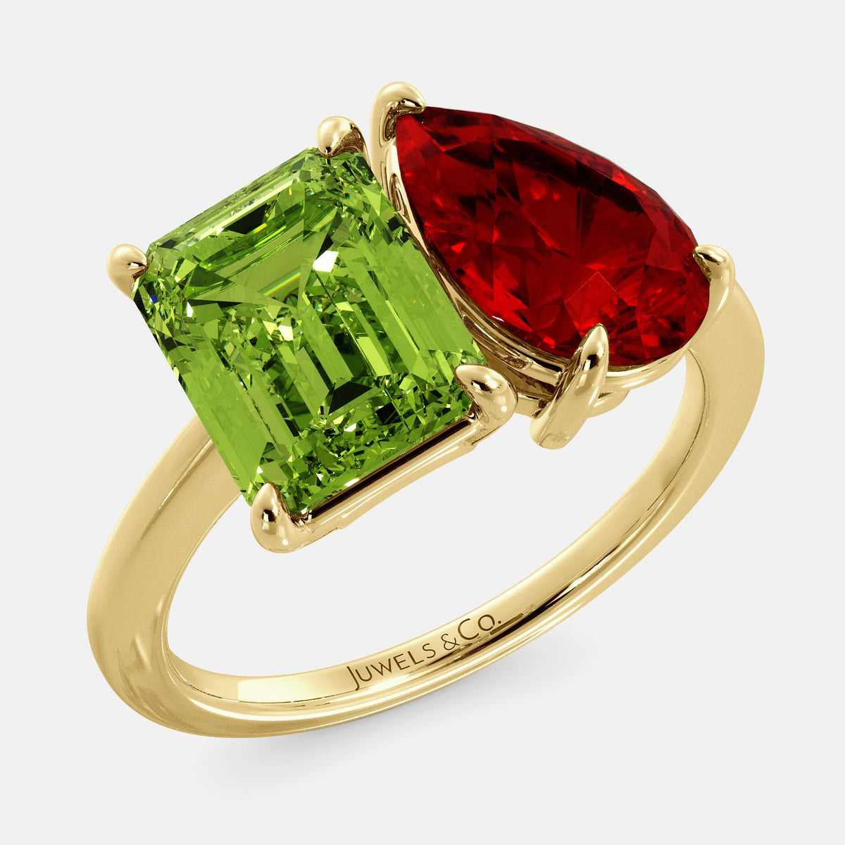 A toi et moi ring with an emerald-cut Green Peridot and a pear-cut gemstone. The emerald-cut morganite is set on the left of the ring, and the pear-cut gemstone is set on the right. The ring is made of recycled yellow gold and has a simple, elegant design. The pear-cut gemstone can be customized. **Here are some additional details about the image:** * The emerald-cut white Green Peridot is a birthstone for August. * The pear-cut gemstone can be customized to any stone of your choice.