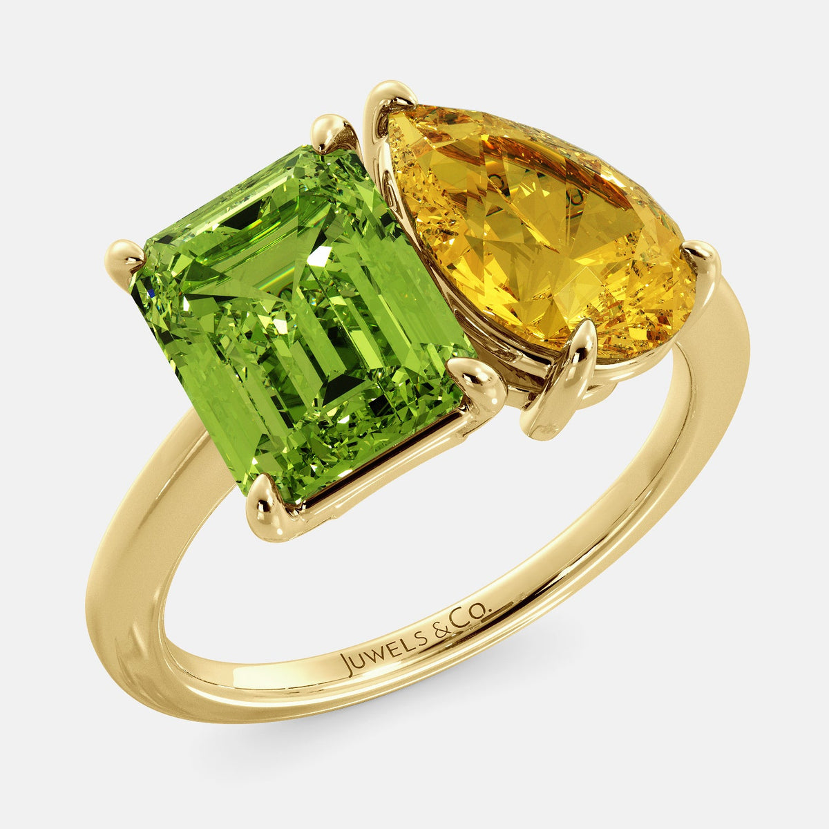 A toi et moi ring with an emerald-cut Green Peridot and a pear-cut gemstone. The emerald-cut morganite is set on the left of the ring, and the pear-cut gemstone is set on the right. The ring is made of recycled yellow gold and has a simple, elegant design. The pear-cut gemstone can be customized. **Here are some additional details about the image:** * The emerald-cut white Green Peridot is a birthstone for August. * The pear-cut gemstone can be customized to any stone of your choice.