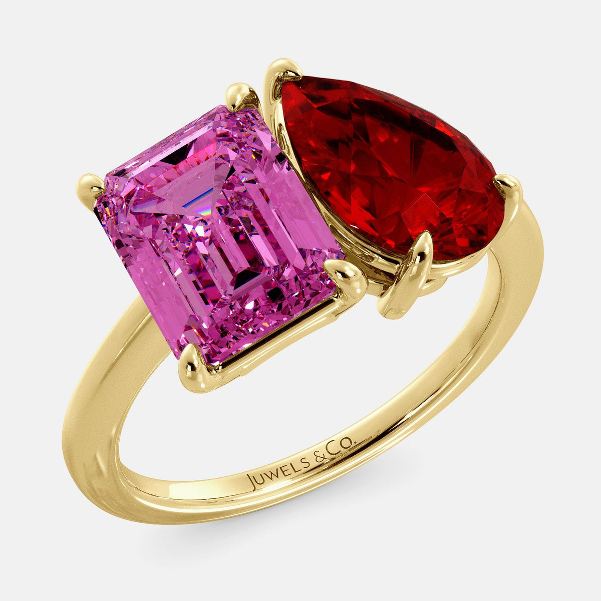 A toi et moi ring with an emerald-cut Pink Sapphire and pear-cut gemstone. The emerald-cut is set on the left of the ring, and the pear-cut gemstone is set on the right. The ring is made of recycled yellow gold and has a simple, elegant design. The pear-cut gemstone can be customized. **Here are some additional details about the image:** * The emerald-cut white Pink Sapphire is a birthstone for October. * The pear-cut gemstone can be customized to any stone of your choice.