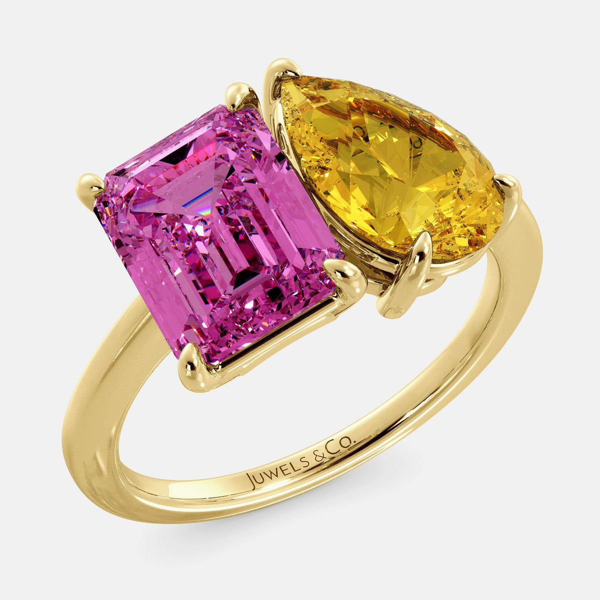 A toi et moi ring with an emerald-cut Pink Sapphire and pear-cut gemstone. The emerald-cut is set on the left of the ring, and the pear-cut gemstone is set on the right. The ring is made of recycled yellow gold and has a simple, elegant design. The pear-cut gemstone can be customized. **Here are some additional details about the image:** * The emerald-cut white Pink Sapphire is a birthstone for October. * The pear-cut gemstone can be customized to any stone of your choice.