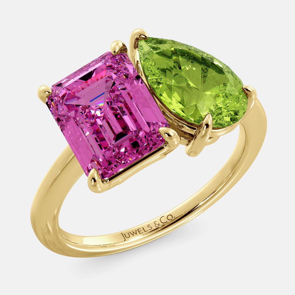 A toi et moi ring with an emerald-cut Pink Sapphire and pear-cut gemstone. The emerald-cut is set on the left of the ring, and the pear-cut gemstone is set on the right. The ring is made of recycled yellow gold and has a simple, elegant design. The pear-cut gemstone can be customized. **Here are some additional details about the image:** * The emerald-cut white Pink Sapphire is a birthstone for October. * The pear-cut gemstone can be customized to any stone of your choice.