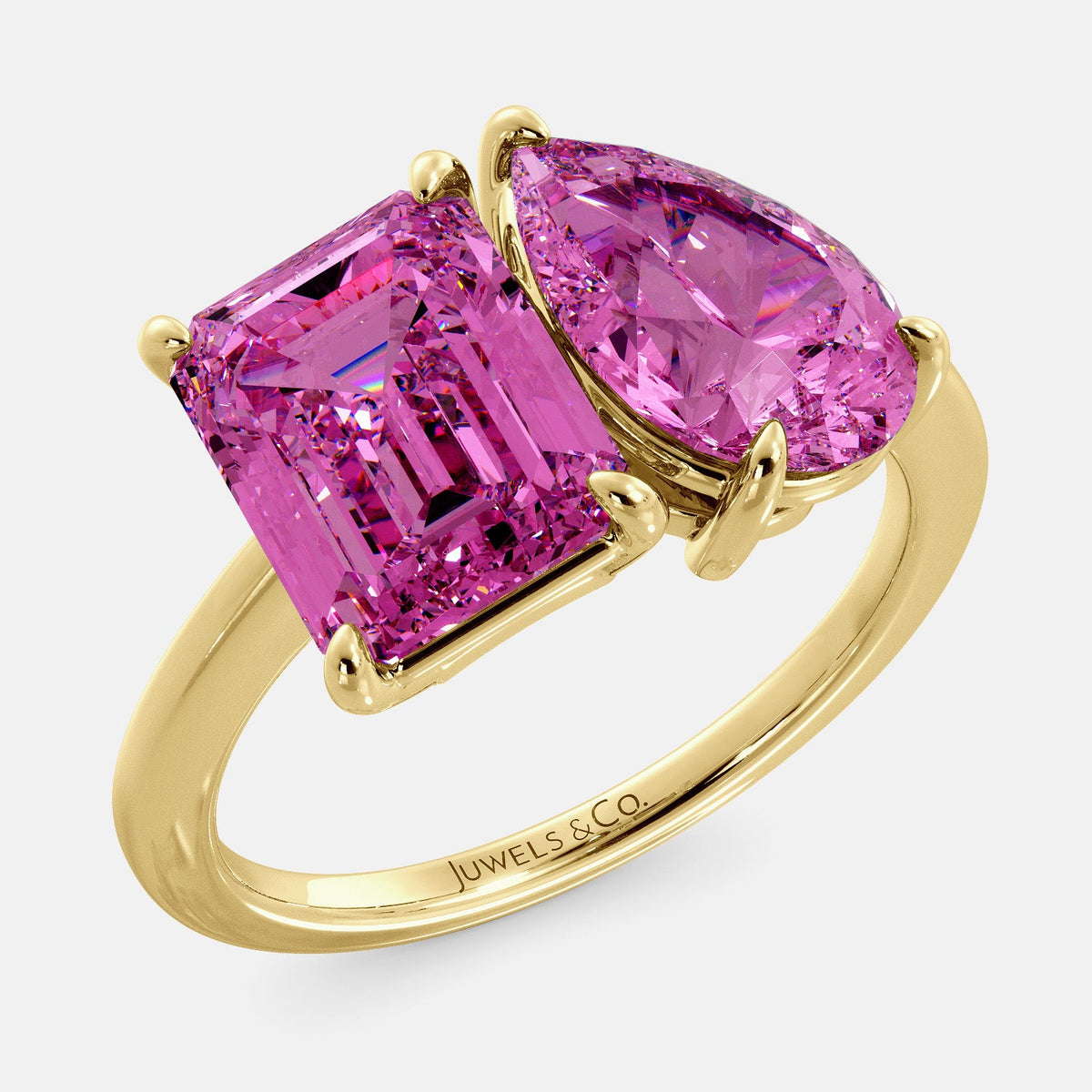 A toi et moi ring with an emerald-cut Pink Sapphire and pear-cut gemstone. The emerald-cut morganite is set on the left of the ring, and the pear-cut gemstone is set on the right. The ring is made of recycled yellow gold and has a simple, elegant design. The pear-cut gemstone can be customized. **Here are some additional details about the image:** * The emerald-cut white Pink Sapphire is a birthstone for October. * The pear-cut gemstone can be customized to any stone of your choice.