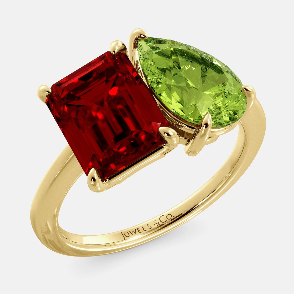 A toi et moi ring with an emerald-cut ruby and a pear-cut gemstone. The emerald-cut morganite is set on the left of the ring, and the pear-cut gemstone is set on the right. The ring is made of recycled yellow gold and has a simple, elegant design. The pear-cut gemstone can be customized. **Here are some additional details about the image:** * The emerald-cut white ruby is a birthstone for July. * The pear-cut gemstone can be customized to any stone of your choice.
