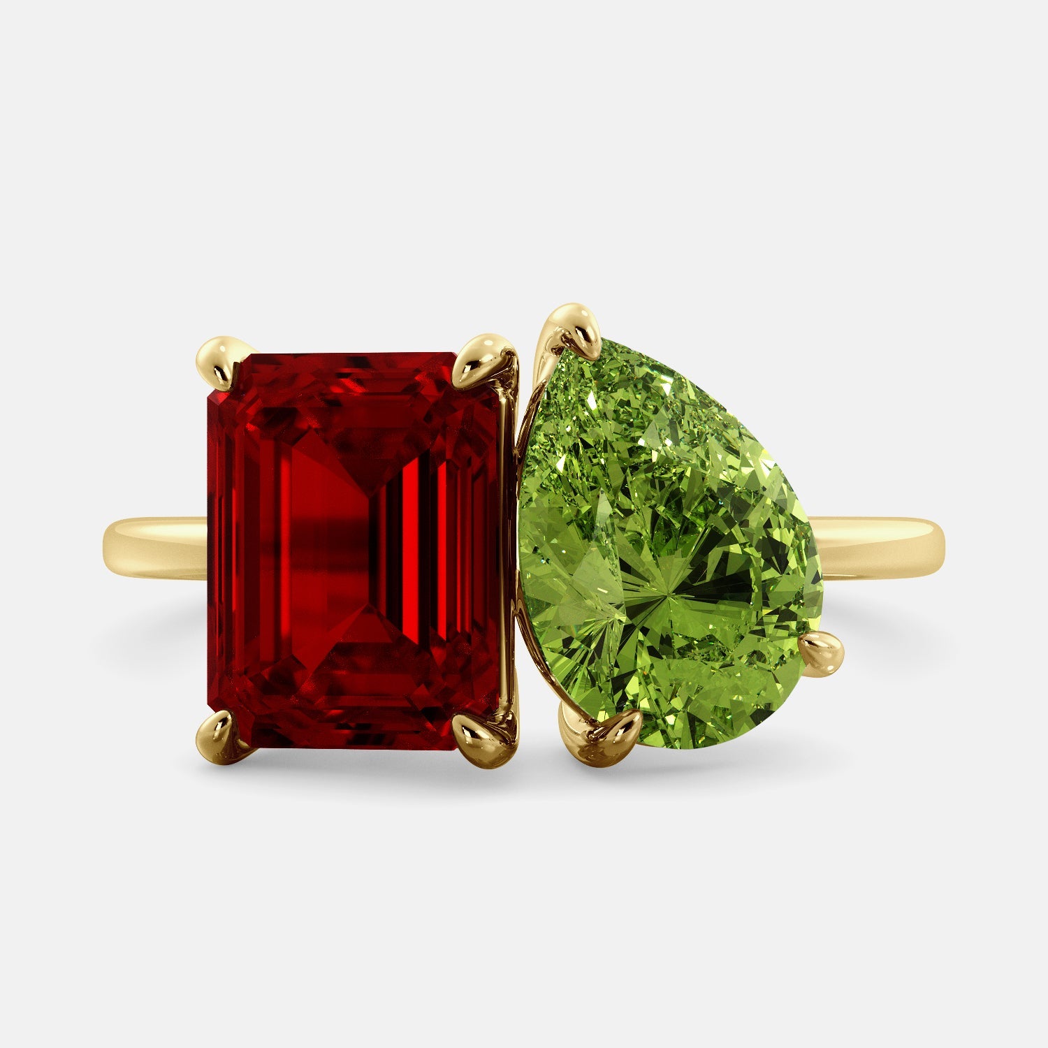 A toi et moi ring with an emerald-cut ruby and a pear-cut gemstone. The emerald-cut morganite is set on the left of the ring, and the pear-cut gemstone is set on the right. The ring is made of recycled yellow gold and has a simple, elegant design. The pear-cut gemstone can be customized. **Here are some additional details about the image:** * The emerald-cut white ruby is a birthstone for July. * The pear-cut gemstone can be customized to any stone of your choice.