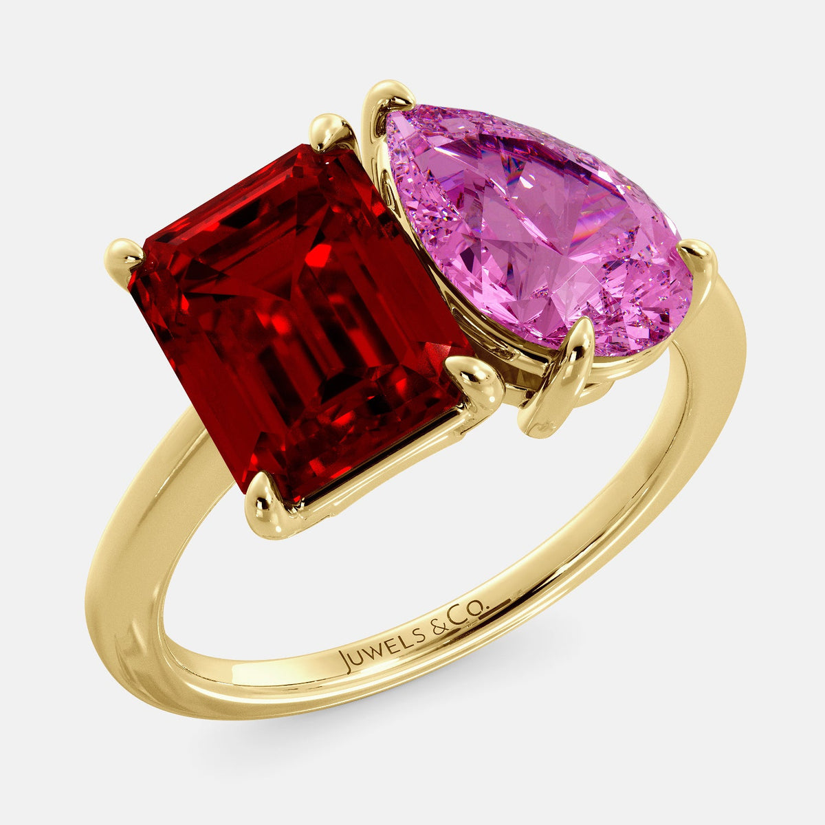 A toi et moi ring with an emerald-cut ruby and a pear-cut gemstone. The emerald-cut morganite is set on the left of the ring, and the pear-cut gemstone is set on the right. The ring is made of recycled yellow gold and has a simple, elegant design. The pear-cut gemstone can be customized. **Here are some additional details about the image:** * The emerald-cut white ruby is a birthstone for July. * The pear-cut gemstone can be customized to any stone of your choice.