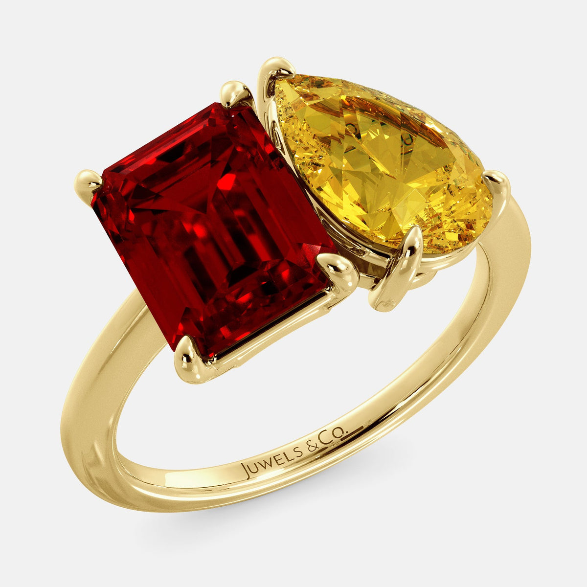 A toi et moi ring with an emerald-cut ruby and a pear-cut gemstone. The emerald-cut morganite is set on the left of the ring, and the pear-cut gemstone is set on the right. The ring is made of recycled yellow gold and has a simple, elegant design. The pear-cut gemstone can be customized. **Here are some additional details about the image:** * The emerald-cut white ruby is a birthstone for July. * The pear-cut gemstone can be customized to any stone of your choice.