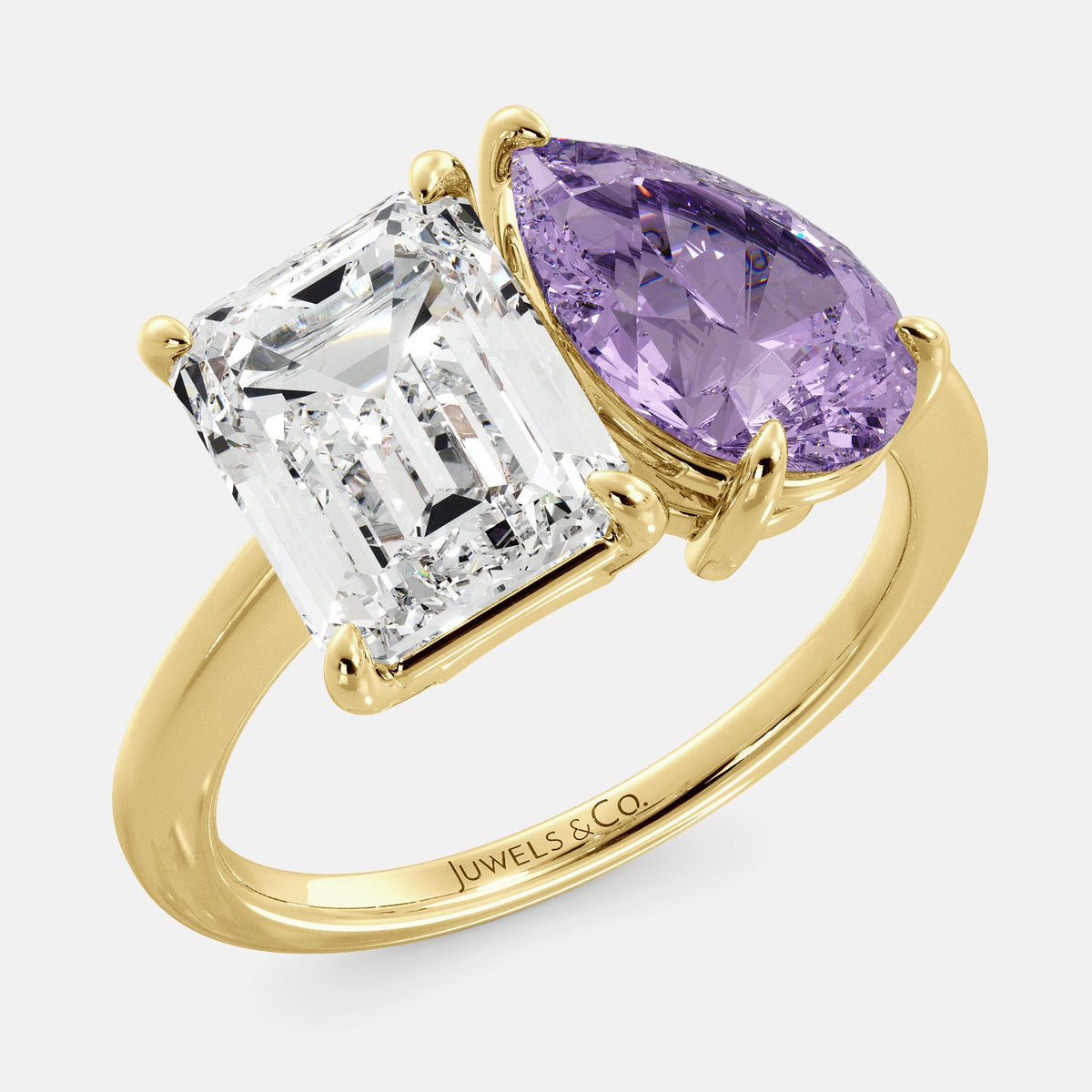 A toi et moi ring with an emerald-cut white topaz and a pear-cut gemstone. The emerald-cut morganite is set on the left of the ring, and the pear-cut gemstone is set on the right. The ring is made of recycled yellow gold and has a simple, elegant design. The pear-cut gemstone can be customized. **Here are some additional details about the image:** * The emerald-cut white topaz is a birthstone for April. * The pear-cut gemstone can be customized to any stone of your choice.