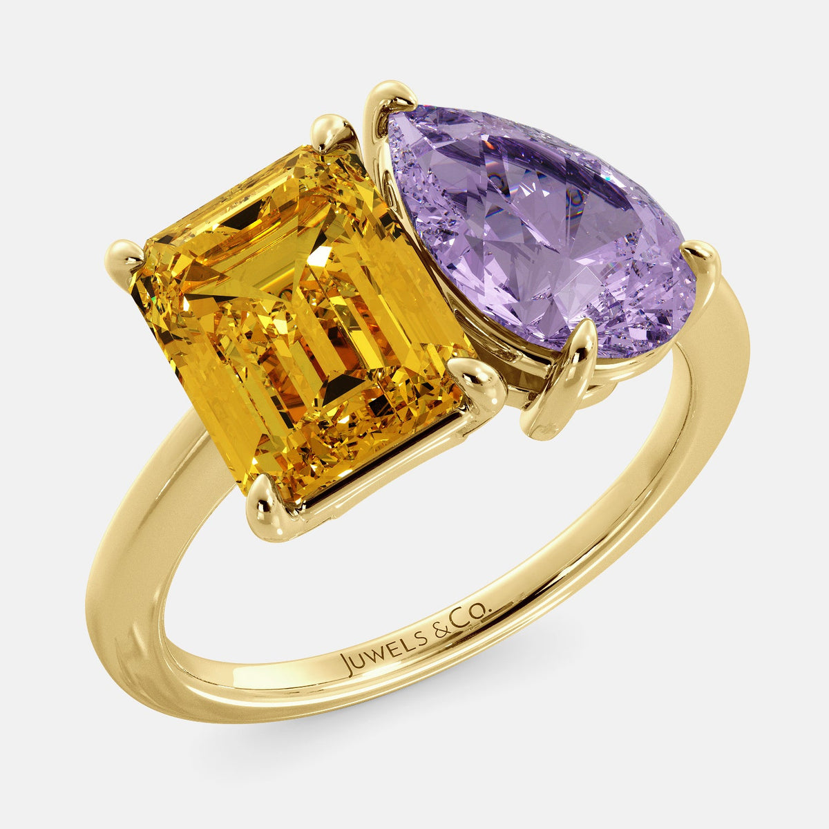 A toi et moi ring with an emerald-cut Citrin and pear-cut gemstone. The emerald-cut morganite is set on the left of the ring, and the pear-cut gemstone is set on the right. The ring is made of recycled yellow gold and has a simple, elegant design. The pear-cut gemstone can be customized. **Here are some additional details about the image:** * The emerald-cut white Citrin is a birthstone for November. * The pear-cut gemstone can be customized to any stone of your choice.