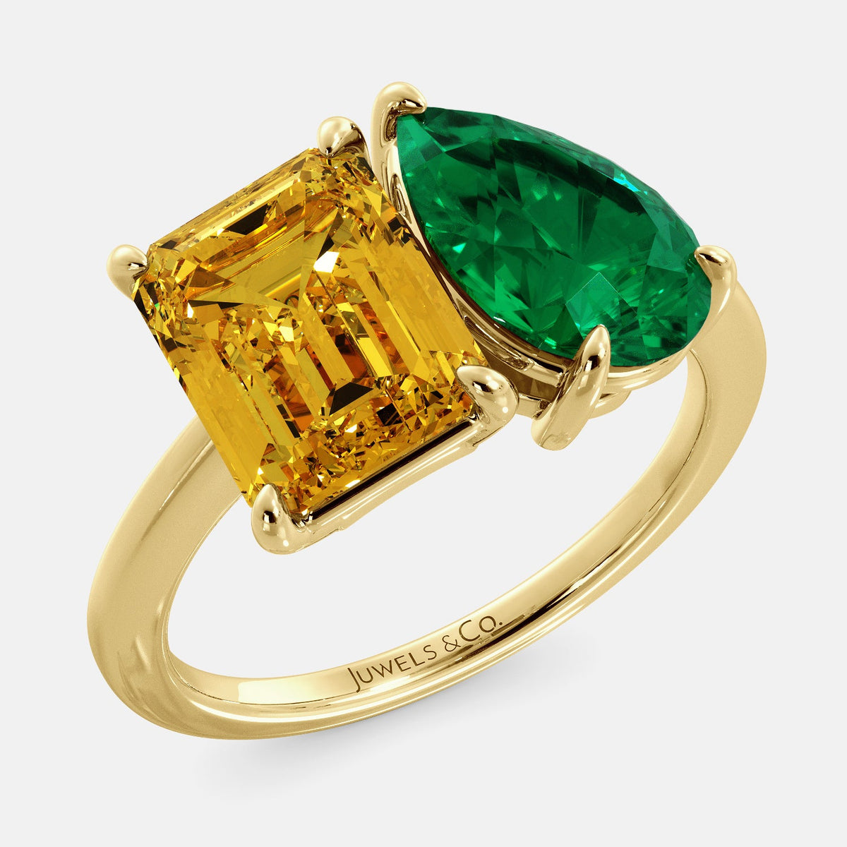 A toi et moi ring with an emerald-cut Citrin and pear-cut gemstone. The emerald-cut morganite is set on the left of the ring, and the pear-cut gemstone is set on the right. The ring is made of recycled yellow gold and has a simple, elegant design. The pear-cut gemstone can be customized. **Here are some additional details about the image:** * The emerald-cut white Citrin is a birthstone for November. * The pear-cut gemstone can be customized to any stone of your choice.